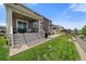 Spacious backyard featuring a covered patio and well-maintained lawn at 848 Sandstone Cir, Erie, CO 80516