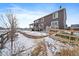 Spacious backyard with a stone retaining wall and partial fence at 848 Sandstone Cir, Erie, CO 80516