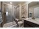 Modern bathroom with a glass-enclosed shower, vanity with a quartz countertop, and neutral decor at 848 Sandstone Cir, Erie, CO 80516