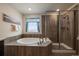 Beautiful primary bathroom with soaker tub and tiled glass shower at 848 Sandstone Cir, Erie, CO 80516