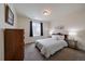 Cozy bedroom with a full size bed, side tables, and a dark curtained window at 848 Sandstone Cir, Erie, CO 80516