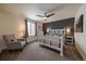 Comfortable bedroom with a ceiling fan, large window, and a dark accent wall at 848 Sandstone Cir, Erie, CO 80516