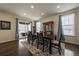 Elegant dining room with stylish furniture, natural light, and access to the outdoor patio at 848 Sandstone Cir, Erie, CO 80516