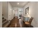 Inviting foyer showcasing hardwood floors, a stylish dresser, and a view into the adjacent living area at 848 Sandstone Cir, Erie, CO 80516