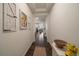 Bright entryway with hardwood floors, decorative wall art, and an inviting view into the home's living spaces at 848 Sandstone Cir, Erie, CO 80516