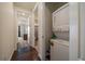 Convenient hallway laundry closet with a stacked washer and dryer for space-saving efficiency at 848 Sandstone Cir, Erie, CO 80516
