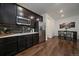 The kitchen features stainless steel appliances, dark cabinets, modern backsplash, and hardwood flooring at 848 Sandstone Cir, Erie, CO 80516