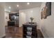 Open kitchen with stainless steel appliances, dark cabinets, and hardwood floors at 848 Sandstone Cir, Erie, CO 80516