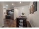 Charming kitchen island with storage solutions complements the modern stainless steel appliances and dark cabinetry at 848 Sandstone Cir, Erie, CO 80516