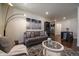 Comfortable living room featuring hardwood floors, modern lighting, and stylish decor at 848 Sandstone Cir, Erie, CO 80516