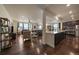 Open-concept living room with hardwood floors, modern furnishings, and an attached island kitchen at 848 Sandstone Cir, Erie, CO 80516