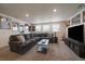 Spacious living room with a large sectional sofa, modern coffee table and movie poster decorations at 848 Sandstone Cir, Erie, CO 80516