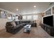 Finished basement living room with sectional couch, large tv, and movie posters at 848 Sandstone Cir, Erie, CO 80516