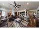 Spacious living room with hardwood floors, modern furniture, and an open layout to the kitchen at 848 Sandstone Cir, Erie, CO 80516