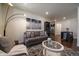 Bright living room featuring a cozy gray sofa, artistic wall decor, and wood flooring at 848 Sandstone Cir, Erie, CO 80516