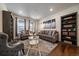 Bright living room with large windows, stylish furniture, and a decorative area rug at 848 Sandstone Cir, Erie, CO 80516