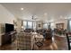 Bright and spacious living room featuring hardwood floors, large windows, and a cozy fireplace at 848 Sandstone Cir, Erie, CO 80516