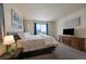 Serene main bedroom offering soft carpet, sliding glass doors to the patio, and a warm, inviting ambiance at 848 Sandstone Cir, Erie, CO 80516