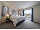 Comfortable main bedroom with large window, plush carpet and access to a private deck at 848 Sandstone Cir, Erie, CO 80516