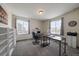 Bright home office featuring a large desk, built in shelving, and natural light at 848 Sandstone Cir, Erie, CO 80516