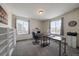 Home office with neutral paint, carpeted floor, and lots of natural light from two windows at 848 Sandstone Cir, Erie, CO 80516