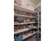 Organized pantry with white shelving provides ample storage for food and kitchen essentials at 848 Sandstone Cir, Erie, CO 80516