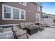 Inviting patio has comfortable seating around a modern fire pit, perfect for outdoor entertaining at 848 Sandstone Cir, Erie, CO 80516