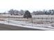 Peaceful street view with snow-covered field and homes in the distance, complete with a speed limit sign at 848 Sandstone Cir, Erie, CO 80516