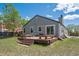 Exterior of home featuring a deck and a large backyard at 11337 E 1St Ave, Aurora, CO 80010