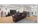 Finished basement area with a large tv, lounge seating, and a bar at 11337 E 1St Ave, Aurora, CO 80010