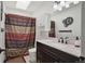 Modern bathroom featuring dark wood cabinets, granite counters, and shower with a shower curtain at 11337 E 1St Ave, Aurora, CO 80010