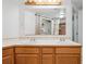 Bathroom vanity featuring double sinks and a large mirror at 11337 E 1St Ave, Aurora, CO 80010
