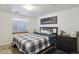 Bedroom featuring a queen bed, nightstand and a window at 11337 E 1St Ave, Aurora, CO 80010