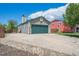Exterior view of house with a spacious driveway leading to the two-car garage at 11337 E 1St Ave, Aurora, CO 80010