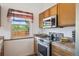 Modern kitchen features stainless steel appliances, lots of cabinet space, and stylish tile backsplash at 11337 E 1St Ave, Aurora, CO 80010