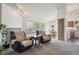 Comfortable living room featuring large windows, and an open floor plan leading to the kitchen and dining area at 11337 E 1St Ave, Aurora, CO 80010