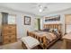 Cozy bedroom with wood furniture and a ceiling fan at 11337 E 1St Ave, Aurora, CO 80010