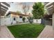 Backyard with a lush green lawn, brick patio, and a decorative water feature at 4525 King St, Denver, CO 80211