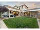 Expansive backyard featuring a manicured lawn and covered patio for outdoor living and entertaining at 4525 King St, Denver, CO 80211