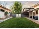 Backyard with a lush green lawn, brick patio, and a decorative water feature at 4525 King St, Denver, CO 80211