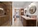Bathroom with decorative wall and floor tiles, dual vanity, and glass enclosed shower at 4525 King St, Denver, CO 80211