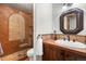 Bathroom featuring a glass walk-in shower with terracotta tile and a wood vanity at 4525 King St, Denver, CO 80211
