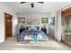 Bright bedroom with an elegant accent wall, balcony doors, and comfortable bench seating at 4525 King St, Denver, CO 80211