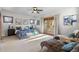 Sunlit bedroom with a decorative balcony, soft textures, and comfortable chaise lounge seating at 4525 King St, Denver, CO 80211
