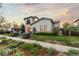 Charming two-story home with manicured lawn, lush landscaping and neutral stucco exterior at 4525 King St, Denver, CO 80211
