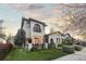 Charming two-story stucco home featuring a quaint balcony, arched windows and manicured landscaping at 4525 King St, Denver, CO 80211