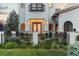 Elegant front entrance with wood double doors, stylish wrought iron fence, and well-kept garden at 4525 King St, Denver, CO 80211