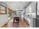 Charming kitchen with a marble island, stainless appliances, terra cotta tile floors, and sliding glass doors at 4525 King St, Denver, CO 80211