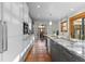 Spacious kitchen leading to the dining area, featuring white cabinetry and stainless appliances at 4525 King St, Denver, CO 80211