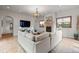 Living room with a stone fireplace, neutral decor, stone floors, and a large sectional at 4525 King St, Denver, CO 80211